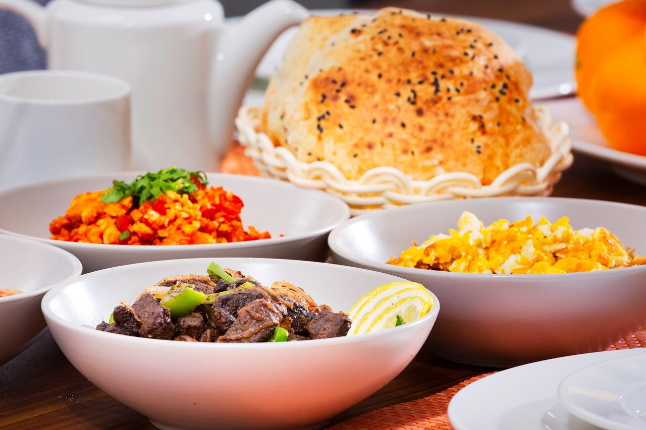 Delicious assortment of colorful dishes in bowls with bread, perfect for a food-centered stock photo.