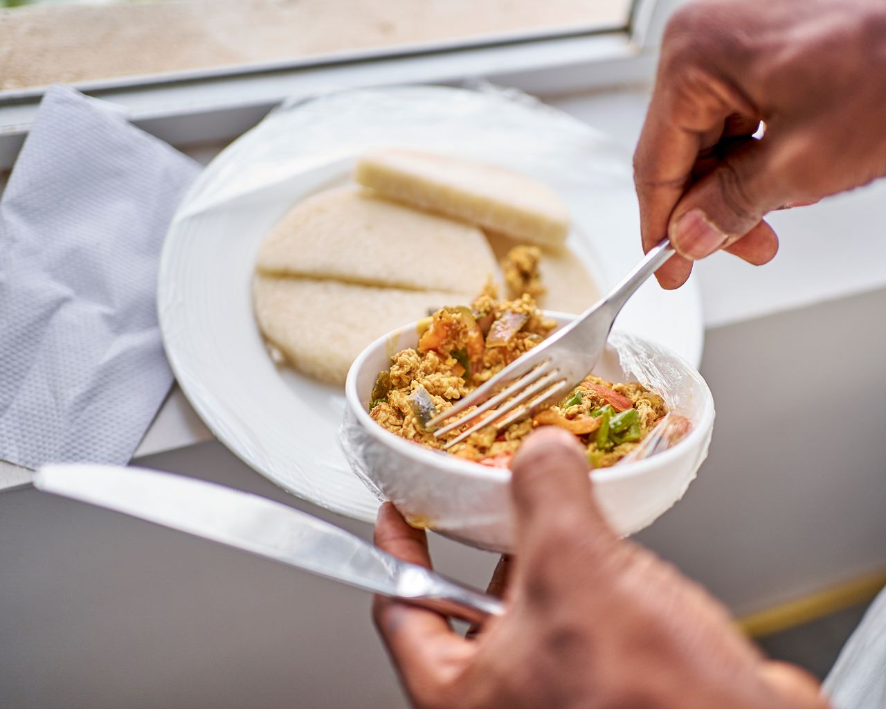 Delicious Nigerian breakfast with yam and egg dish in natural light.